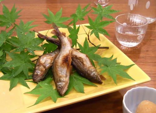 a yellow plate with three vegetables on a table at Ryokan Sumiya Kihoan in Kameoka
