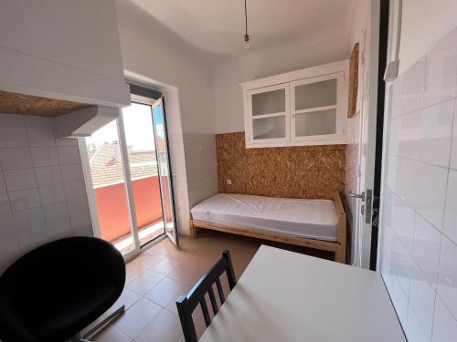 a small room with a bed and a window at Olaias13 in Lisbon