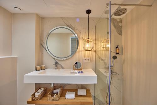 a bathroom with a sink and a shower with a mirror at Tomir Portals Suites - Adults Only in Portals Nous