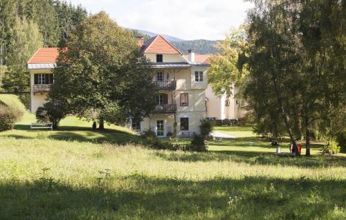 a large white house with trees in a field at Hotel Landsitz Pichlschloss in Neumarkt in Steiermark