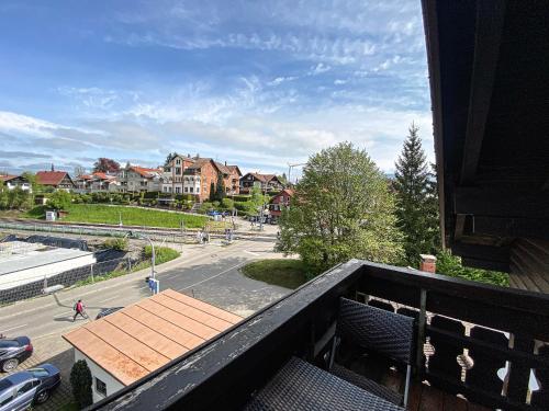 a balcony with a view of a street and buildings at FEWO Alex in Oberstaufen
