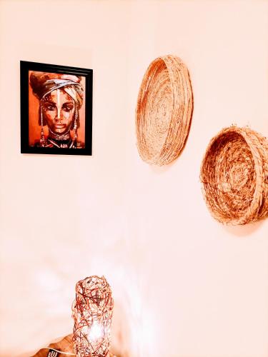 two baskets hanging on a wall with a picture at La quercia di Massena in Lauria