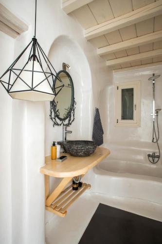a bathroom with a sink and a bath tub at Villa Alitis by Mykonos Rocks in Mikonos