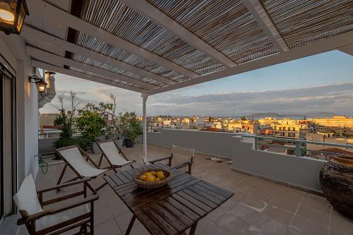 a patio with a table and chairs on a balcony at Apostolos Loft - Cozy Loft in the Center of Preveza in Preveza