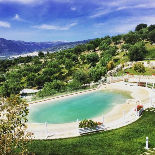 a large pool of water next to a beach at Hotel Residence Il Porto in Mattinata