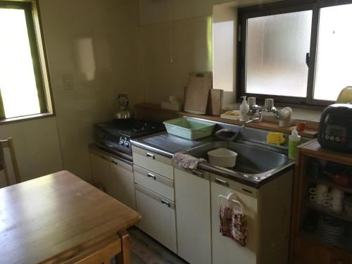 a kitchen with a sink and a counter top at Guesthouse In Lak'ech - Vacation STAY 03558v in Kami-ikusaka