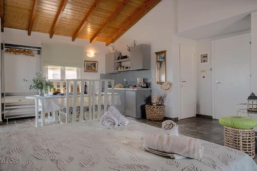 a living room with a table and a kitchen at Apostolos Loft - Cozy Loft in the Center of Preveza in Preveza