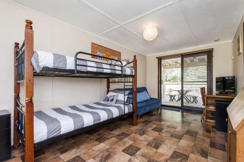 a bedroom with two bunk beds and a desk at Relax Moore - Close to Beach in Guilderton