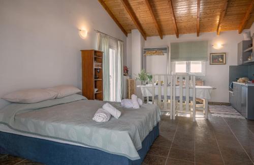 a bedroom with a bed and a kitchen with a table at Apostolos Loft - Cozy Loft in the Center of Preveza in Preveza