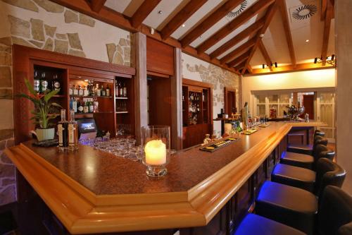 a bar in a restaurant with a candle on the counter at Hotel Bernstein Prerow in Prerow