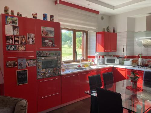 a kitchen with red cabinets and a counter top at Stephanie's Home in Pettorano sul Gizio