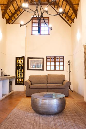 a living room with a couch and a coffee table at MILIMA Big 5 Safari Lodge in Hoedspruit