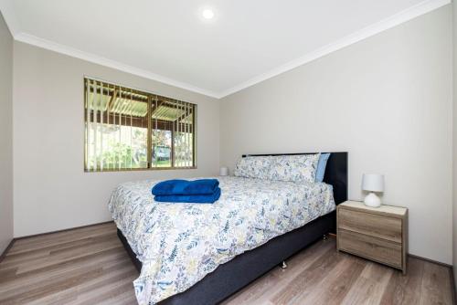 a bedroom with a large bed and a window at Waves And Moore - Beautifully presented home in Guilderton