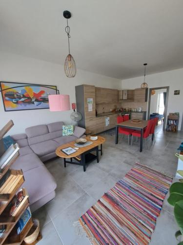 a living room with a couch and a table at the Queen Freddy Penthouse in Taʼ Xbiex