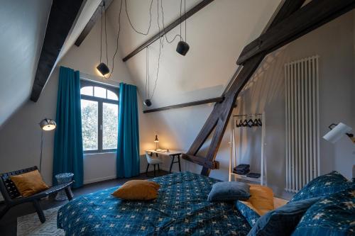 a bedroom with a large bed and a window at Havenhuis Brugge in Bruges