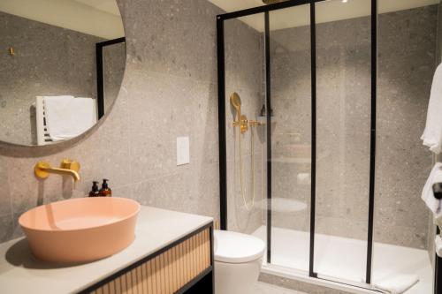 a bathroom with a sink and a shower at Bob W Lübeck Old Town in Lübeck