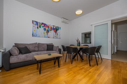 a living room with a couch and a table at Villa Veronika Apartments in Crikvenica