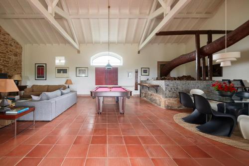 a living room with a pool table in the middle at Luxury Farmhouse with Swimming Pool, By TimeCooler in Sobral de Monte Agraço