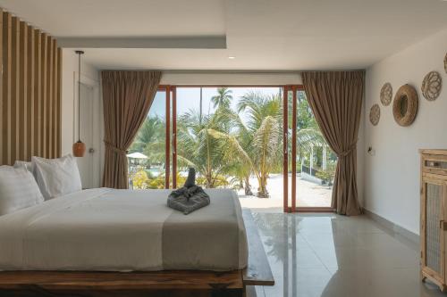 a bedroom with a large bed and a large window at Anaya Koh Rong in Koh Rong Island