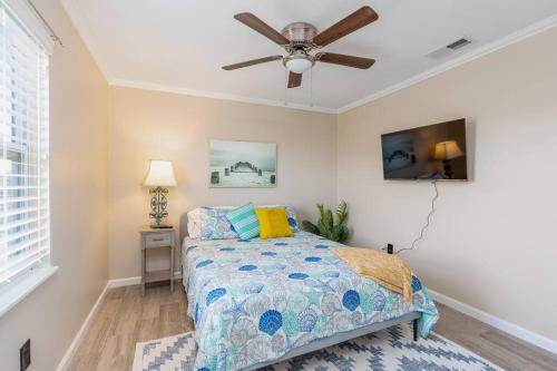 a bedroom with a bed and a ceiling fan at Crescent Beach Bungalow B in Saint Augustine
