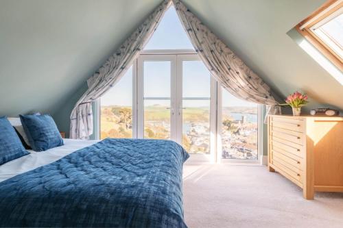 a bedroom with a bed and a large window at Old Sail Loft in Salcombe