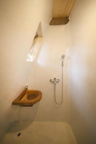 a bathroom with a wooden sink and a shower at Captain Ikaros in Agios Kirykos