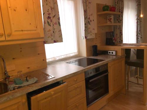 a kitchen with a sink and a stove at Waldhaus in Hinterstoder