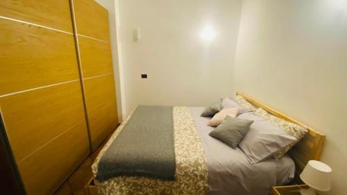 a small bedroom with a bed with pillows on it at La casa tra gli ulivi di Fonte Nuova 1 in Fonte Nuova