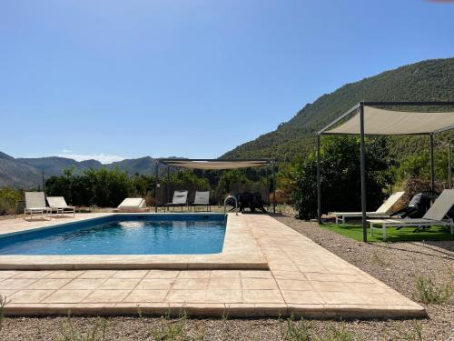 a swimming pool with a view of a mountain at Casas Amarillas. Finca el Campillo in Blanca