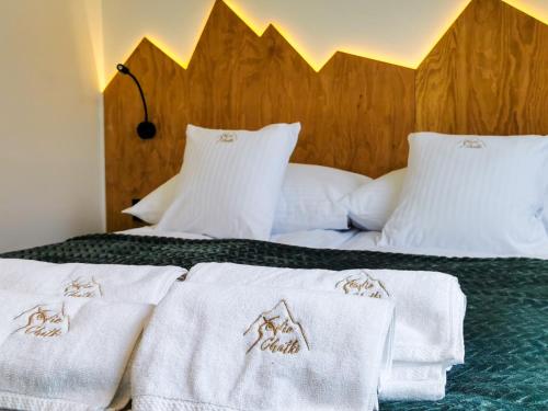 a bedroom with two beds with white towels on them at Sowie Chatki - domki z widokiem na Góry Sowie in Sokolec