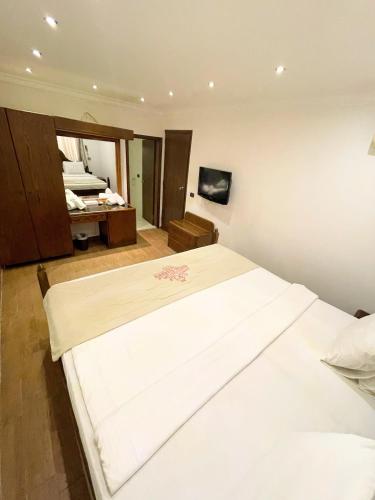 a bedroom with a large white bed in a room at Royal Garden Hotel in Beirut
