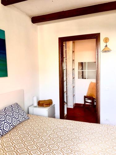 a bedroom with a bed and a door to a room at La casa di Giulio in Maccarese