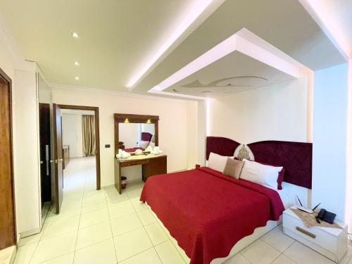 a bedroom with a red bed and a mirror at Royal Garden Hotel in Beirut