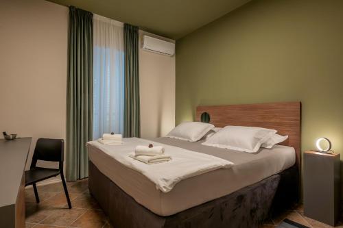 a bedroom with a bed with two towels on it at Green, deluxe two bedroom suite in Split