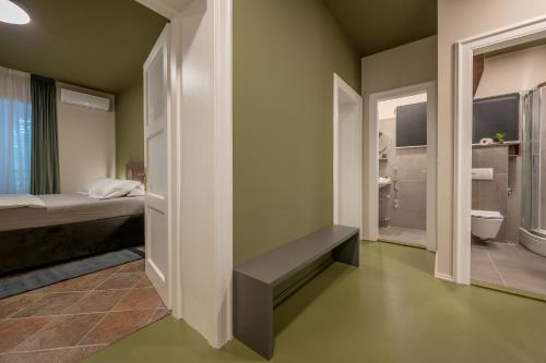 a bedroom with a bed and a bathroom with a toilet at Green, deluxe two bedroom suite in Split