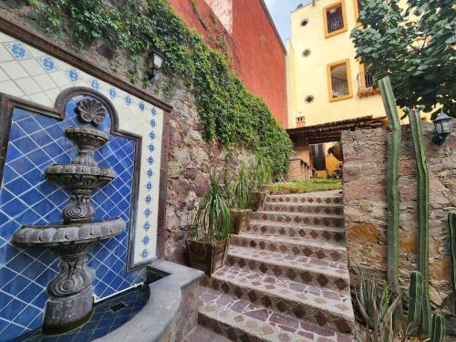 a set of stairs with a fountain next to a building at Casita Privada del Chan in Guanajuato