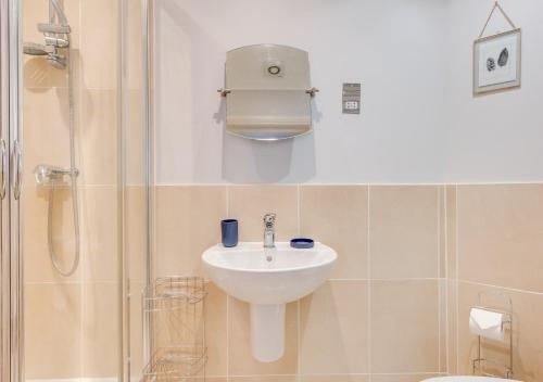 y baño con lavabo y ducha. en Flat 1 Deco, en Swanage