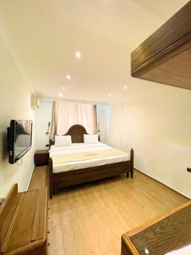 a bedroom with a bed and a television in it at Royal Garden Hotel in Beirut