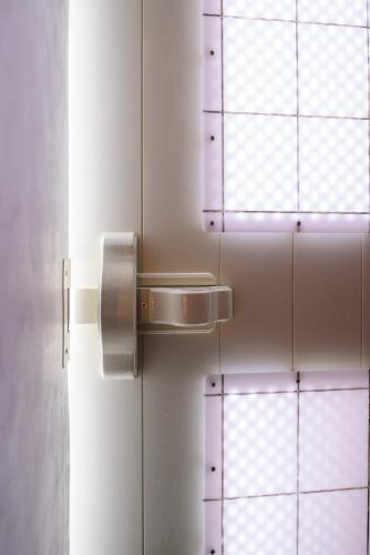 a door with a paper towel dispenser on a wall at Casa Delle Botti Cave House Santorini Oia Finikia in Foinikiá