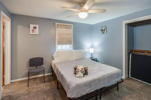 a bedroom with a bed with a ceiling fan and a chair at Centric Ranch in the South ave by Dwtn/UofR/Arpt in Rochester