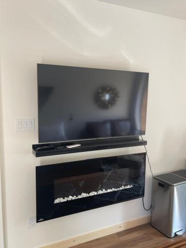 a fireplace with a flat screen tv on top of it at Evo Luxury Waterfront Adults Only B&B in Tobermory