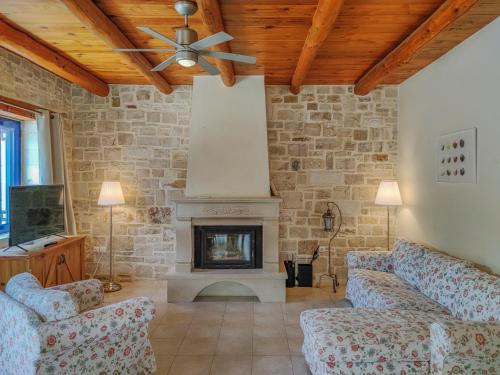a living room with two couches and a fireplace at Lemon Tree Villa with Private Pool and Starlink Internet in Frés