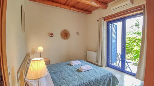 a bedroom with a bed and a large window at Lemon Tree Villa with Private Pool and Starlink Internet in Frés