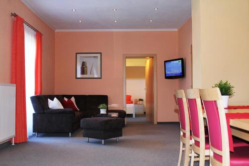 a living room with a couch and a chair at B&B Appartement Das Stoaberg in Leogang