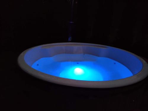 a blue bath tub in a dark room at Sena Troba in Druskininkai