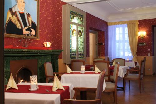 a dining room with tables and a fireplace at Stadtschloß Hecklingen in Hecklingen