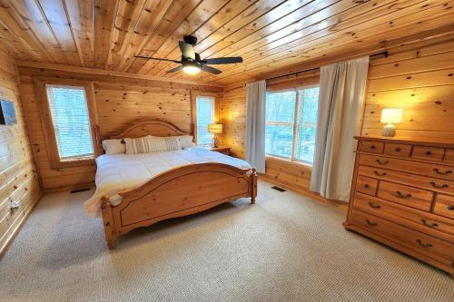 a bedroom with a bed and a wooden ceiling at Good Hart Haven in Harbor Springs