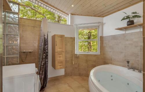 baño con bañera y ducha y ventana en Lovely Home In Spttrup With House Sea View, en Lihme
