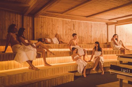 a group of people sitting in a sauna at Hotel Frymburk in Frymburk