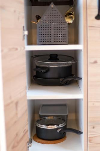 a shelf with a pot and pans in a kitchen at Tiny Pick in Apetlon